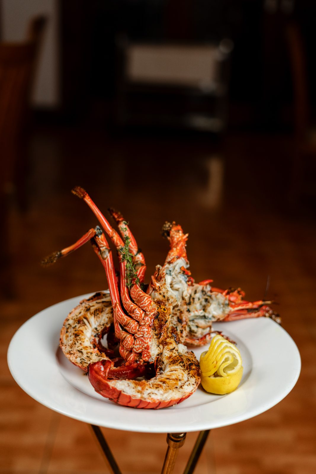 Whole flame-grilled langouste, Amigo's signature dish