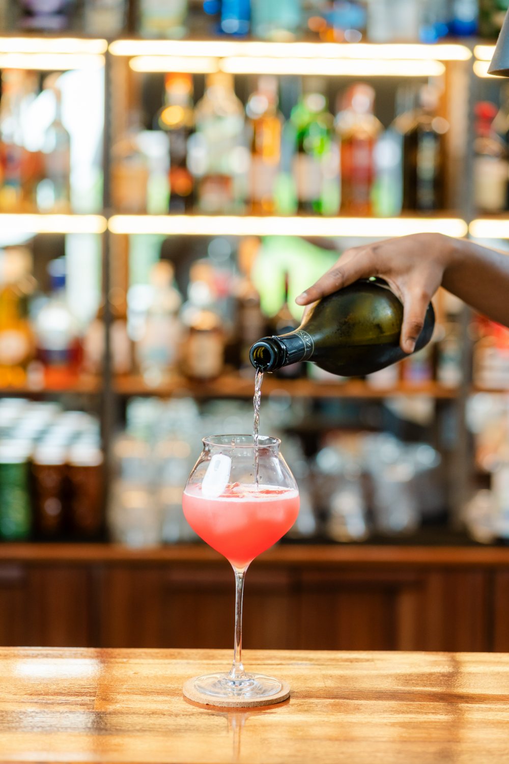 Sparkling wine poured over a cocktail at Amigo Bar & Bistro