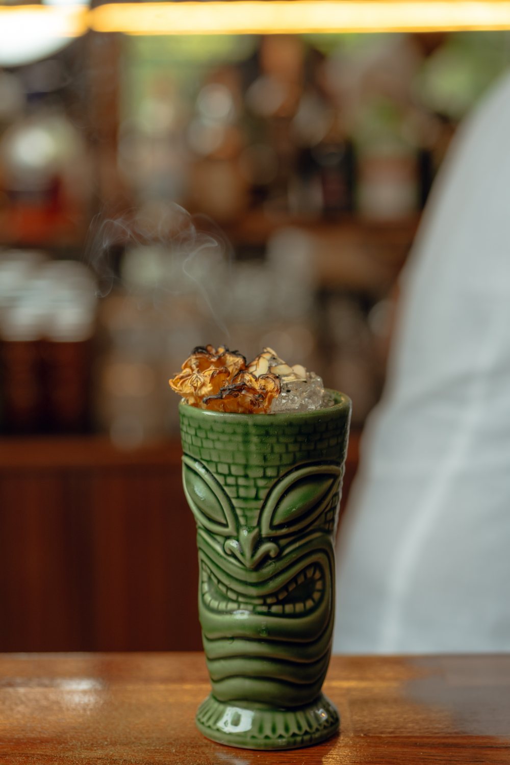 A smoking tiki cocktail on the counter at Amigo Bar & Bistro