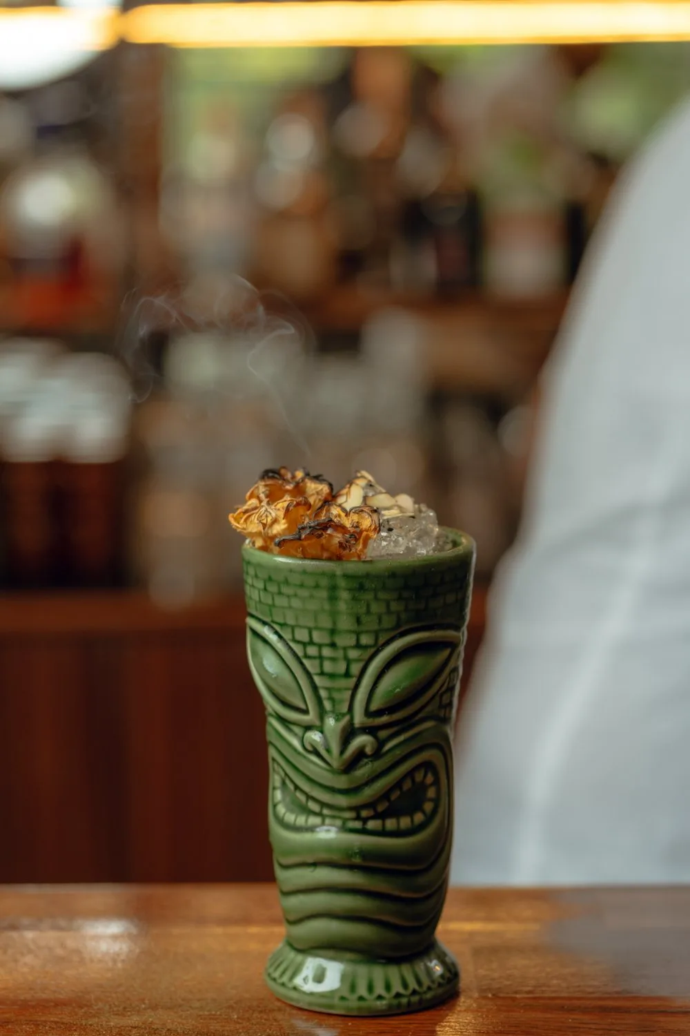 A smoking tiki cocktail on the counter at Amigo Bar & Bistro