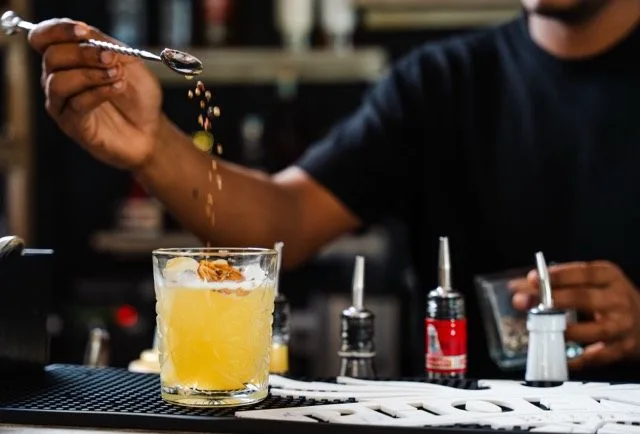 Garnishing a cocktail at the Amigo Bar & Bistro counter