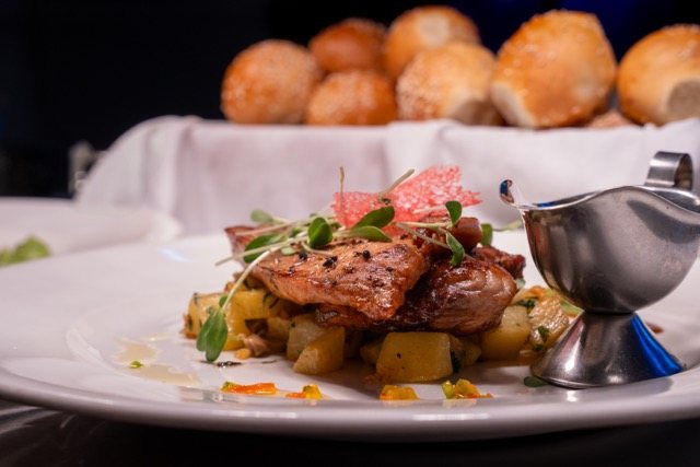 Grilled fish of the day with sauteed potatoes and a jug of sauce at Amigo