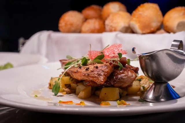 Grilled fish of the day with sauteed potatoes and a jug of sauce at Amigo