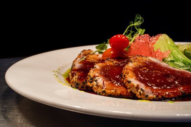 Seared red tuna in a dark glaze with pak choi at Amigo